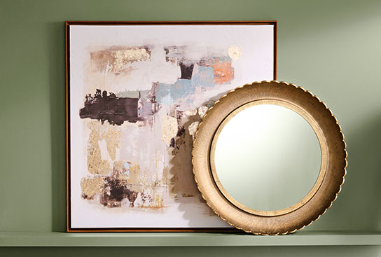Abstract canvas wall art & an intricate gilded mirror.